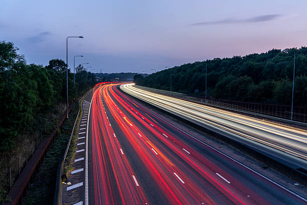 istock Light trails illuminating highway at dusk, creating dynamic streaks of red and white 2227157123