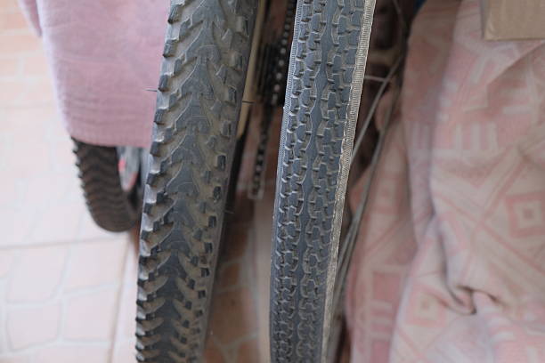 A close up of a bicycle tire with a black and white filter