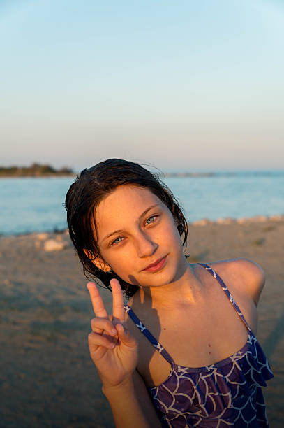 red-haired woman in sunglasses on the beach near the sea fresh air vacation side view. High quality photo