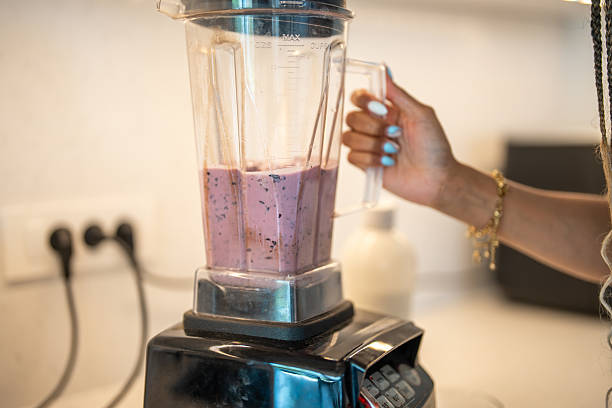 istock Hispanic Woman Blending Fresh Blueberry Smoothie in Modern Kitchen Setting 2227160460