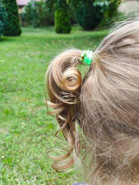 istock Blonde hair pulled back into a cute ponytail. Baby curls. 2227160612