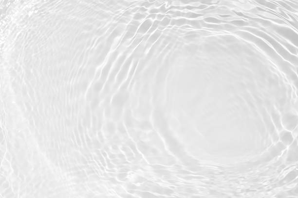 istock White water with ripples on the surface. Defocus blurred transparent white colored clear calm water surface texture with splashes and bubbles. Water waves with shining pattern texture background. 2227161397