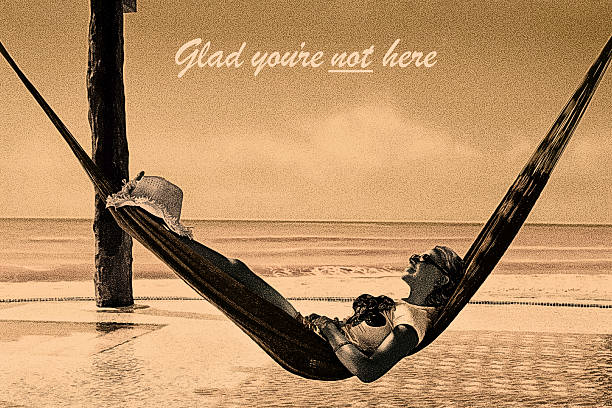 Vintage Postcard with one serene woman relaxing in hammock enjoying tranquil tropical beach. Solitude No crowds.