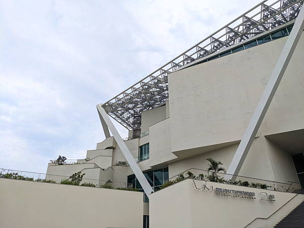 Tainan, Taiwan - May 26 2025: Low angle view of the striking white deconstructivist facade and intricate metal roof of the modern art museum's Building 2, a major cultural landmark