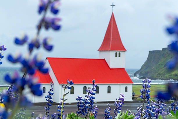 Flatey is a remote island of the western islands, a cluster of about forty large and small islands and islets located in Breidafjordur on the northwestern part of Iceland. In terms of size, Flatey is some two kilometers long and about one kilometer wide, of which most is flat land (hence its name, meaning flat island in Icelandic), with scarcely any hills to be found.\nThe island has only a single road, which leads from the ferry dock to the so-called old village, which consists of some restored and traditionally painted old houses of the island's original inhabitants. Beautifully preserved old houses in cheerful colours embody the spirit and prosperity that the island enjoyed as the commercial and fishing hub of Breidafjordur during its heyday around 1900.\nThe island inhabits the oldest and smallest library in Iceland, established in 1864. Flatey also has a church, built in 1926.\nFlatey Island, Breidafjordur, Iceland.