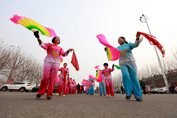Kasghar, Xinjiang Province, China - October 20, 2025 : Dancer wearing a vibrant, multi-colored costume performing a classical and folk Chinese ribbon dance, known as Cai Dai Wu Dao, part of a cultural event at the yards of Afaq Khoja complex.It is a form of Chinese dance, an evolution of the water sleeve dance, and is often linked to the imagery of the \
