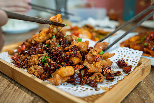 istock Spicy Szechuan Diced Chicken Being Shared with Chopsticks 2227176772