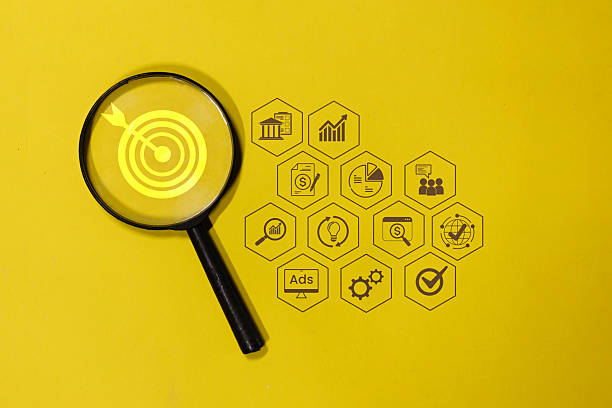 istock Two magnifying glasses with a target and a dollar sign in the middle 2227178448