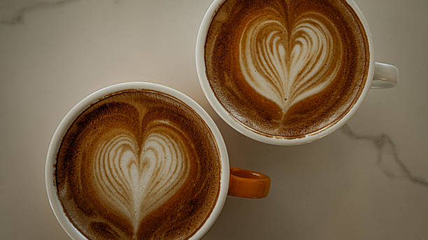 istock Cups of coffee decorated with a heart 2227179637