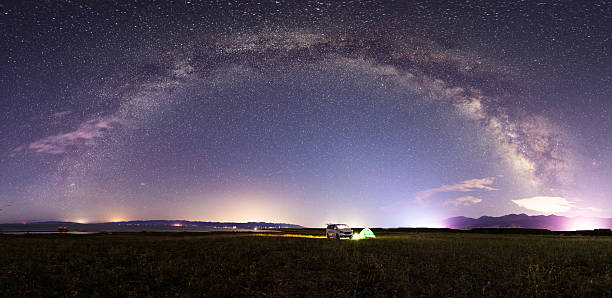 istock Stunning Night Sky with Milky Way Arching Over Open Field 2227179729