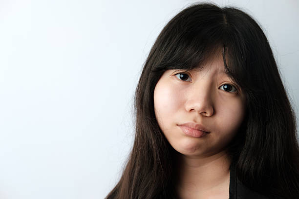 istock Young Asian Woman with Serious Expression and Copy Space 2227181397