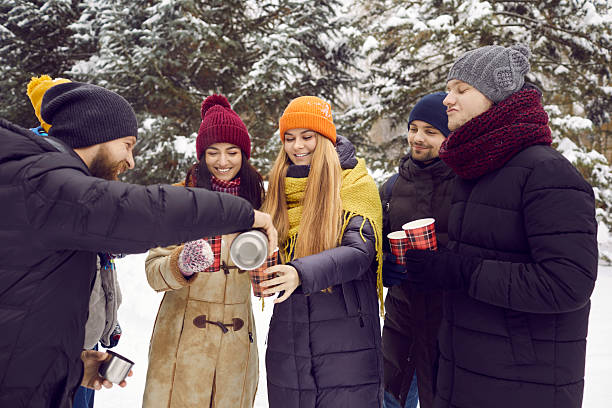 istock Smiling young people warm up with tea during winter walk 2227182175
