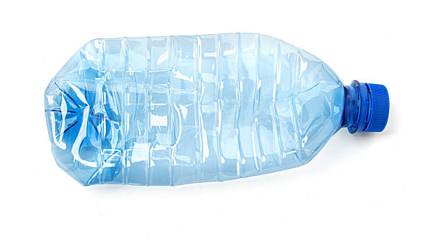 istock Crushed empty plastic water bottle with blue cap on white background 2227182870