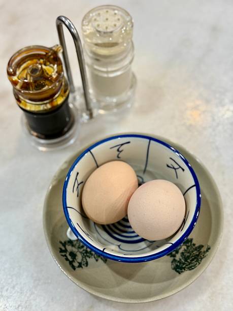 Two soft boiled eggs in porcelain bowl