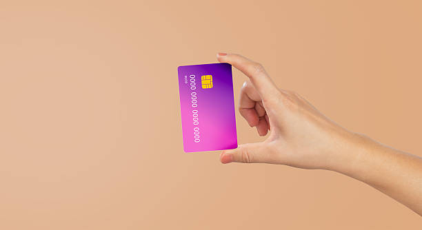 istock Hand hold credit card isolated on beige background. 2227196764