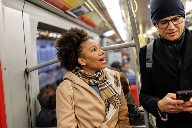 istock Multiracial couple of tourists using mobile phone while traveling by subway train 2227196926