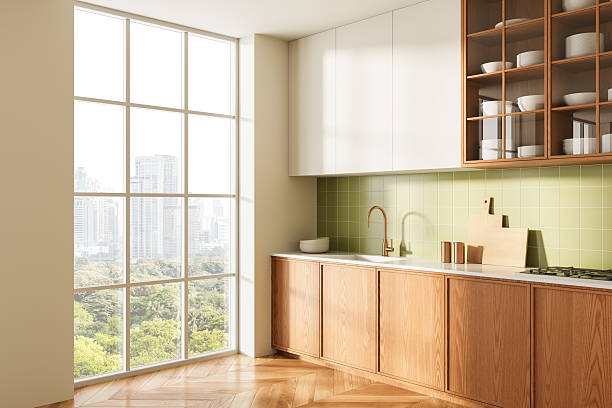 istock Modern minimalist kitchen interior with large window, wooden cabinets, green tile backsplash, and city view in daylight. 3D Rendering. 3D Rendering 2227197817