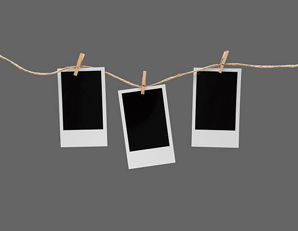 istock Aesthetic Blank Polaroids Hanging On A Rope 2227198540