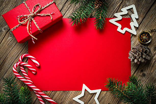 istock Blank greeting card or invitation for Christmas Holidays, rustic and old fashioned background. Flat lay and decor, gift box and fir tree border. Red color 2227206523