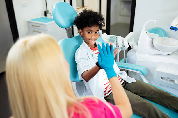 istock Young boy giving high five to dentist after checkup 2227210246