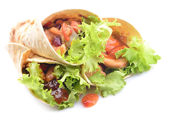 Mexican burrito with chicken and vegetables on a white background