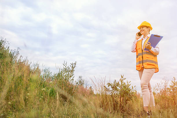istock Female engineer conducting fieldwork with clipboard in a natural environment 2227210999