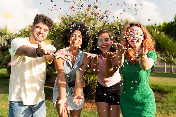 istock Friends throwing confetti in the air 2227211529
