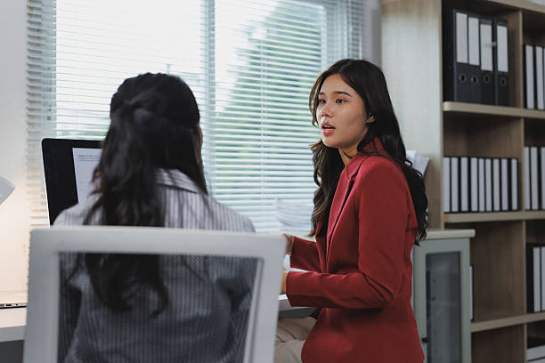 istock Two businesswomen discussing work in modern office 2227213039