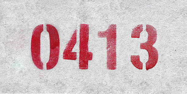 istock red spray-painted number 0413 sprayed onto a white wall. 2227213291
