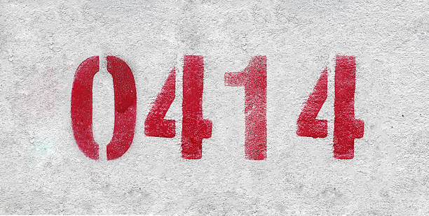 istock Red Number 0414 on the white wall. Spray paint. 2227213294