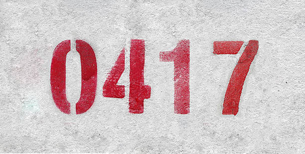 istock Red Number 0417 on the white wall. Spray paint. 2227213314