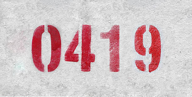 istock red spray-painted number 0419 sprayed onto a white wall. 2227213323