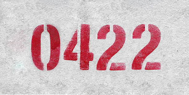 istock red spray-painted number 0422 sprayed onto a white wall. 2227213330