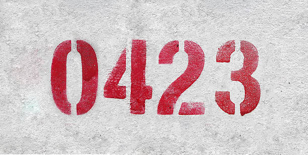 istock Red Number 0423 on the white wall. Spray paint. 2227213331