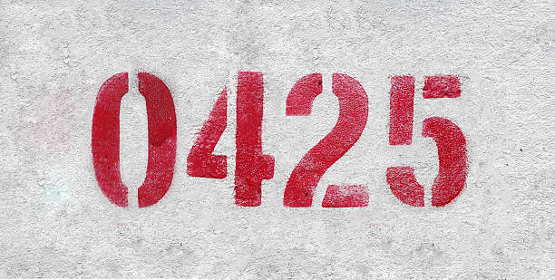 istock red spray-painted number 0425 sprayed onto a white wall. 2227213332