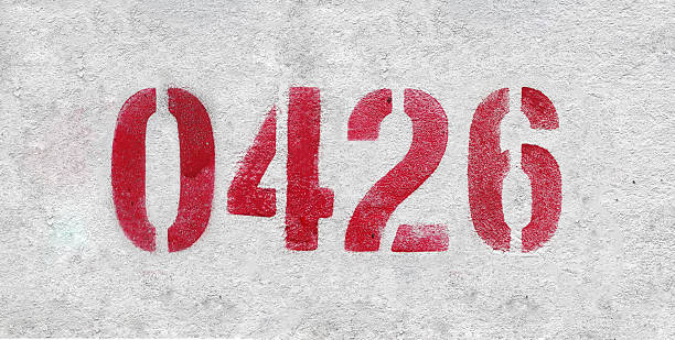 istock Red Number 0426 on the white wall. Spray paint. 2227213335