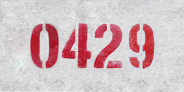 istock Red Number 0429 on the white wall. Spray paint. 2227213352