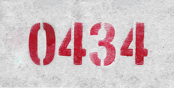 istock red spray-painted number 0434 sprayed onto a white wall. 2227213366