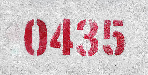 istock Red Number 0435 on the white wall. Spray paint. 2227213371