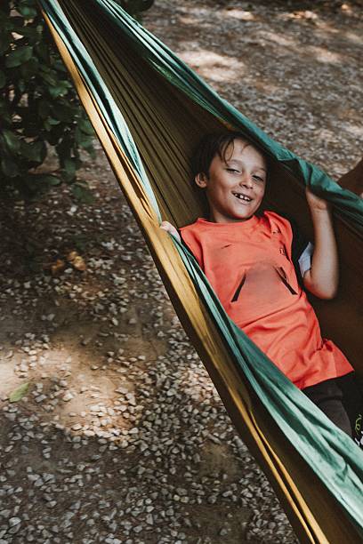 istock Child Relaxing Happily in a Hammock Outdoors 2227213376
