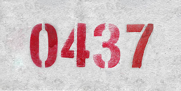 istock red spray-painted number 0437 sprayed onto a white wall. 2227213384
