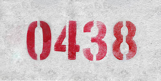 istock Red Number 0438 on the white wall. Spray paint. 2227213387