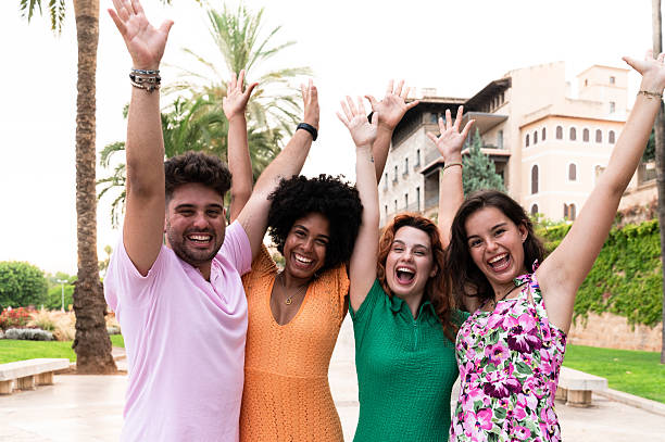 Friends raising arms enjoying summer vacation