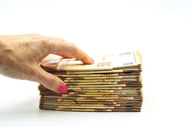 istock A woman's hand holding a bundle of 50 euro bills, white background. 2227216868