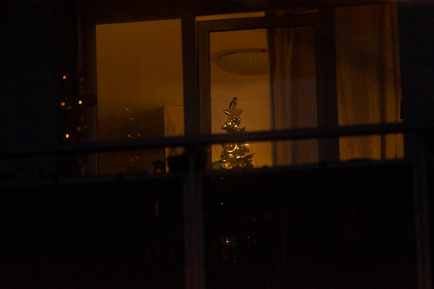 istock A beautifully decorated Christmas tree can be seen through a window at night 2227218246