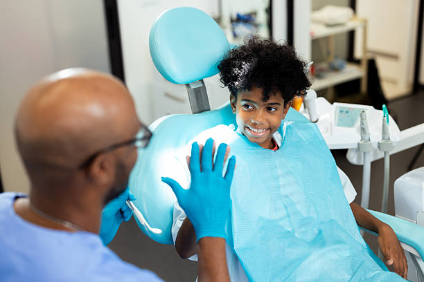 istock Young patient giving high five to dentist after checkup 2227218680