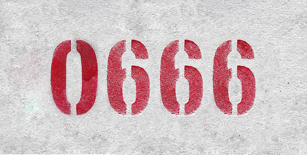 istock Red Number 0666 on the white wall. Spray paint. 2227221792
