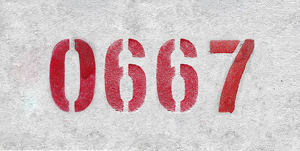 number 0667 . Red spray paint the white wall