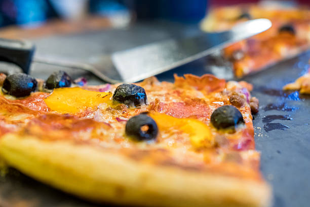 Close up of Pizza on the table with triangular shape pizza peel