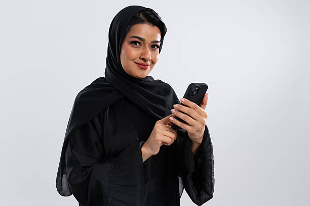 istock Muslim businesswoman using smartphone in studio setting 2227225167